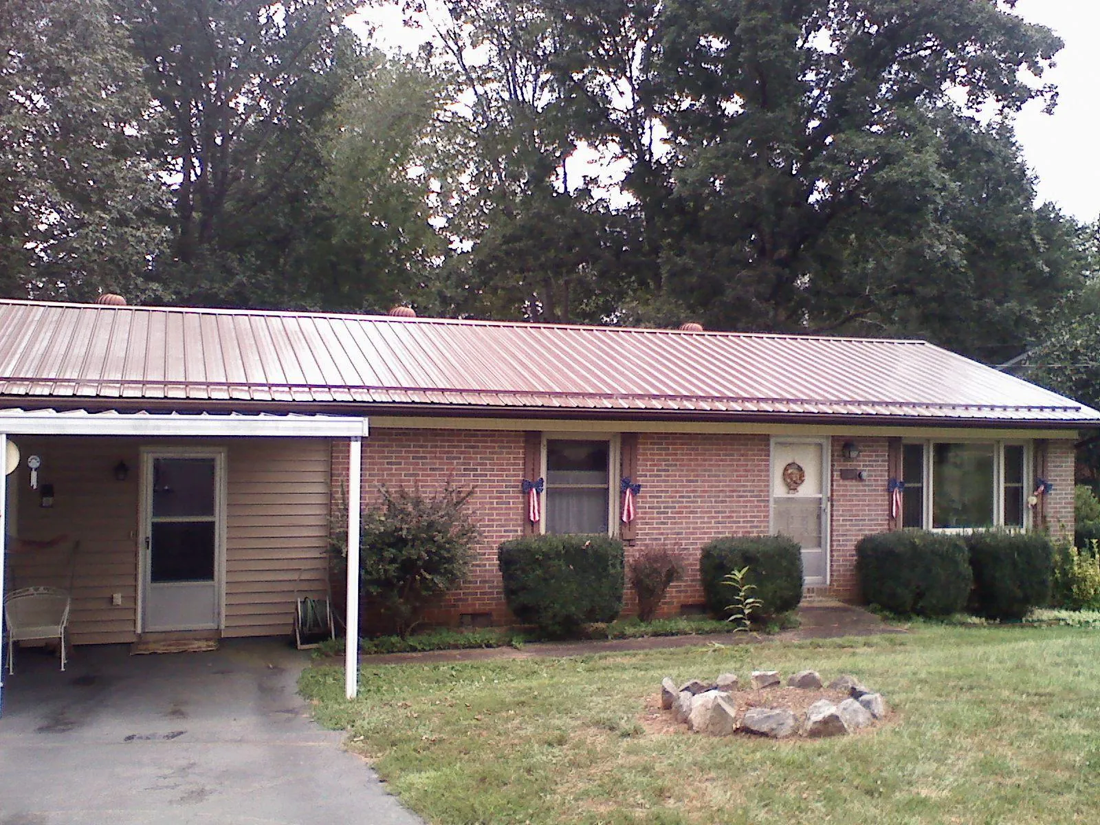 Bronze metal roof and carport on a brick ranch home — Roof Repair work by our crew in Beavercreek