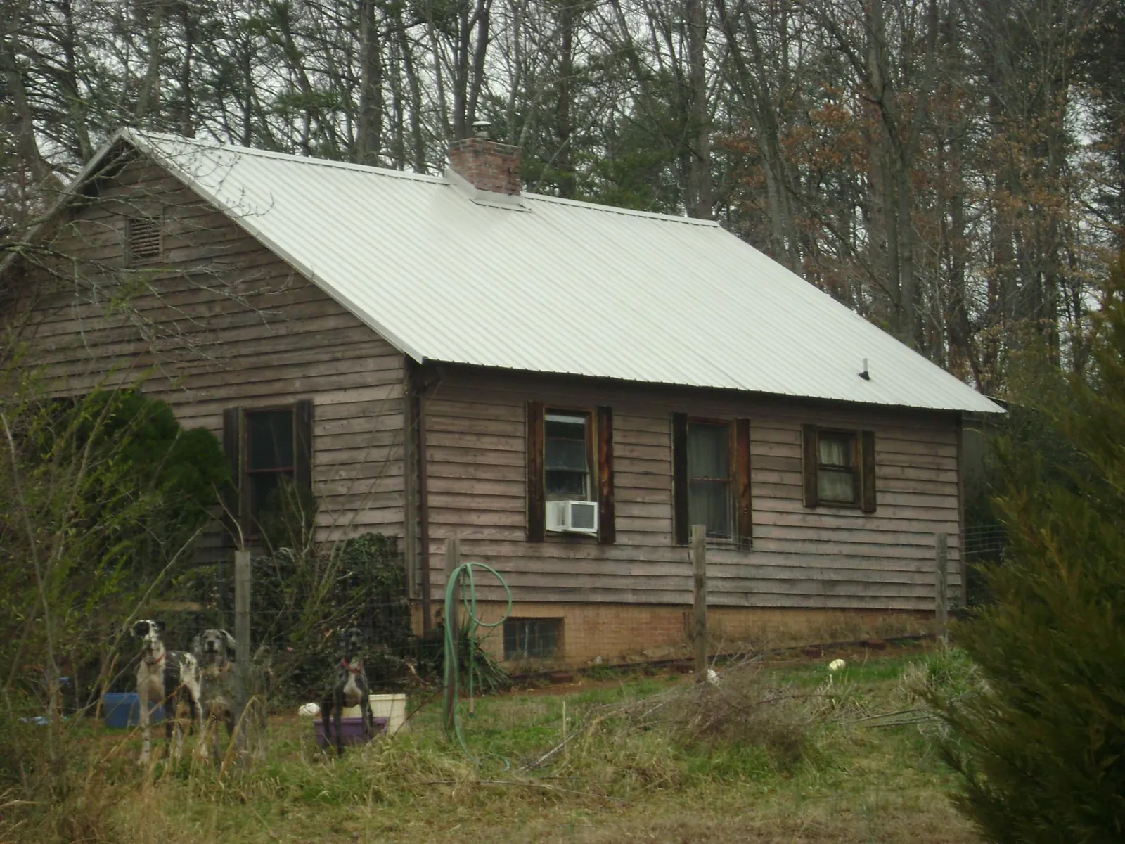 White metal roof on an old wood sided farmhouse, from a Metal Roof Installation job in Beavercreek